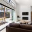 Large sliding glass doors in a living room, pulled open to lead to an outdoor patio