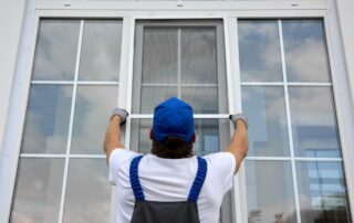 Contractor installing a single window onto a large window pane