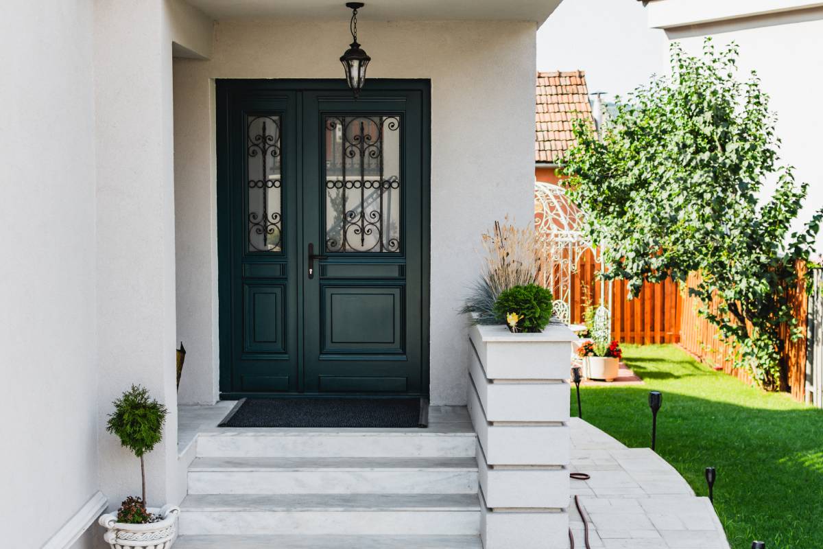 A modern black front door with black hardware and decorative elements on the glass and sidelight at Gilkey Windows & Exterior Solutions near Lexington, KY