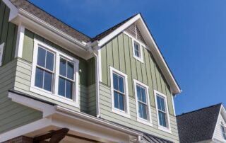 Green vinyl siding color on a home's exterior with white trim around the home and windows at Gilkey Windows & Exterior Solutions near Lexington, KY