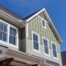 Green vinyl siding color on a home's exterior with white trim around the home and windows at Gilkey Windows & Exterior Solutions near Lexington, KY