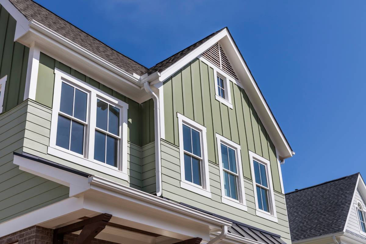 Green vinyl siding color on a home's exterior with white trim around the home and windows at Gilkey Windows & Exterior Solutions near Lexington, KY