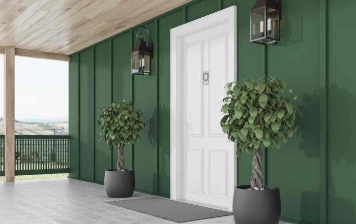 New, white front door on a dark green exterior with modern house lights and potted plants at Gilkey Windows & Exterior Solutions near Lexington, KY