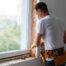 Window expert using caulk as part of the process of installing new windows in a residential home at Gilkey Windows & Exterior Solutions near Lexington, KY