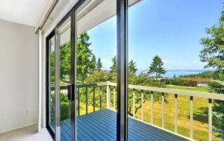 A new, sleek sliding glass door in a residential home overlooking a scenic backyard at Gilkey Windows & Exterior Solutions near Lexington, KY