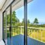 A new, sleek sliding glass door in a residential home overlooking a scenic backyard at Gilkey Windows & Exterior Solutions near Lexington, KY