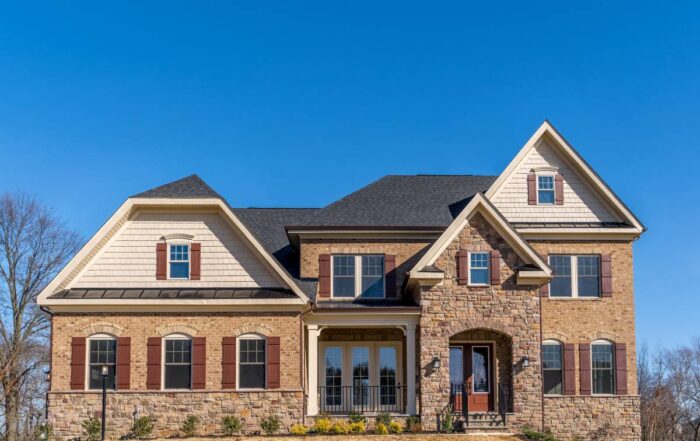 Home with window trim matching the sliding doors and matching exterior shutters to the front door at Gilkey Windows & Exterior Solutions near Lexington, KY