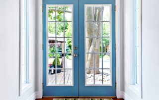 Interior view of blue exterior French doors leading out to a home's garden space