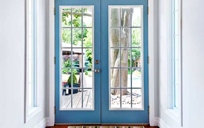 Interior view of blue exterior French doors leading out to a home's garden space