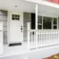 A white front door, a light front door color, on the porch of a home