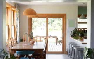 A traditional sliding glass door with a wood frame in a kitchen, leading out to patio