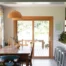A traditional sliding glass door with a wood frame in a kitchen, leading out to patio